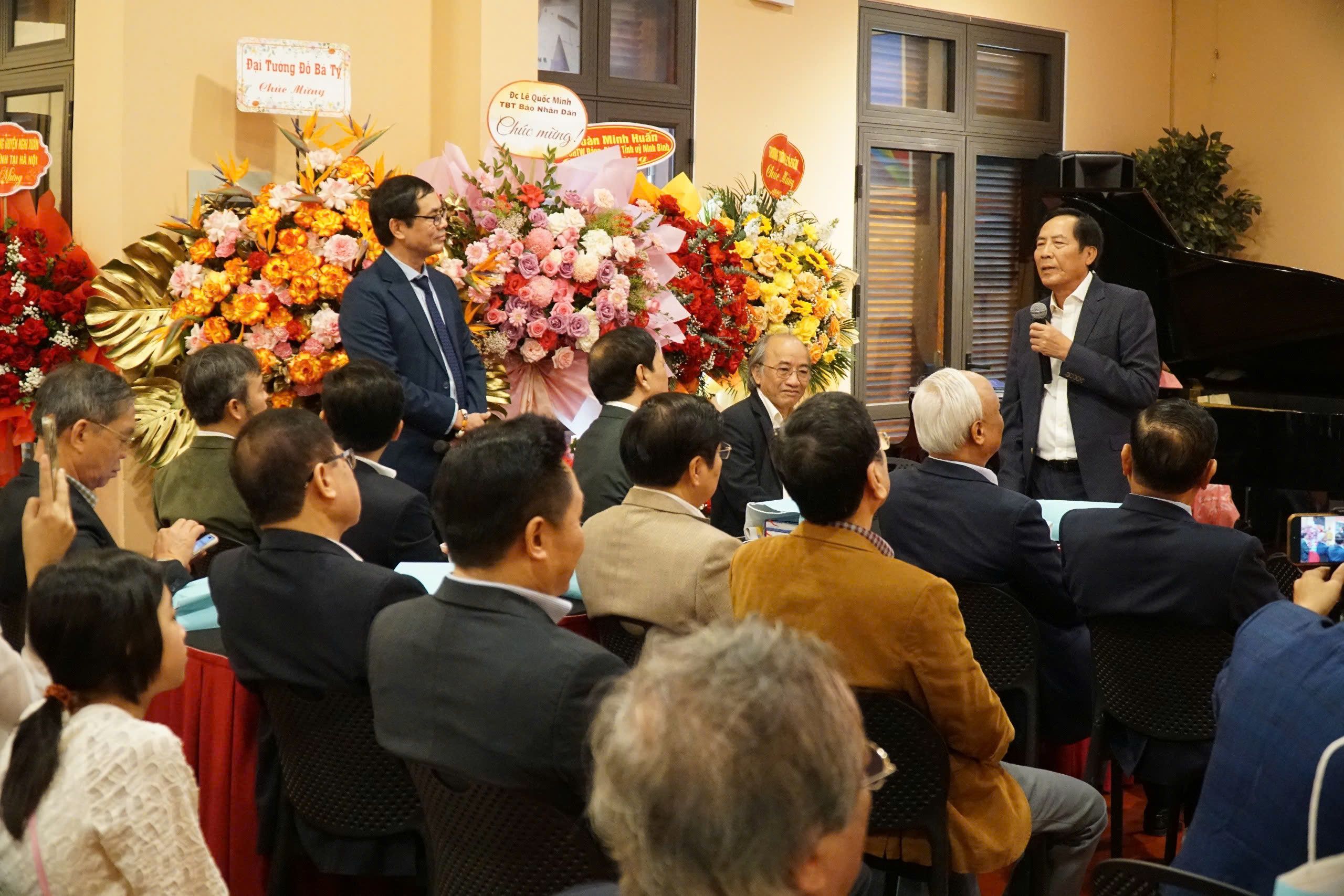 Hundreds of small orange flowers in bloom against green grass.
